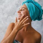 Best sunscreen for anti-aging in your 30s — woman applying SPF as part of morning skincare routine