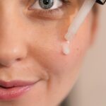 How to use hyaluronic acid in your 30s — woman applying serum as part of morning skincare routine