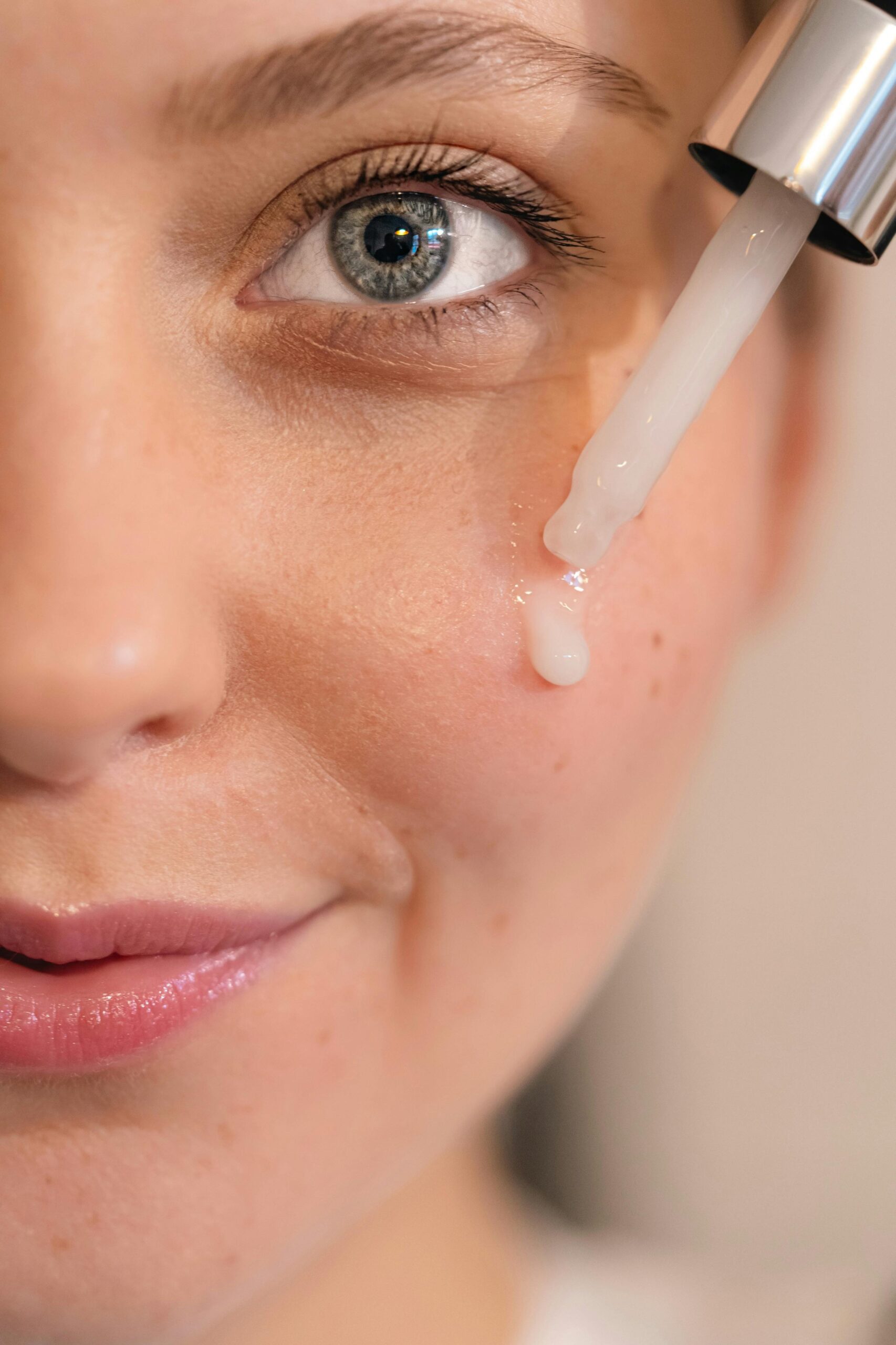 How to use hyaluronic acid in your 30s — woman applying serum as part of morning skincare routine