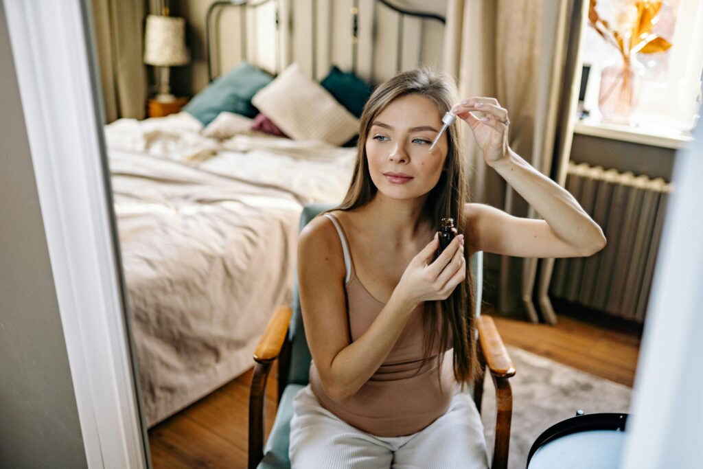 Woman applying niacinamide serum as part of her 30s skincare routine