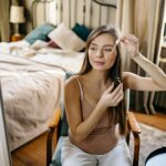 Woman applying niacinamide serum as part of her 30s skincare routine
