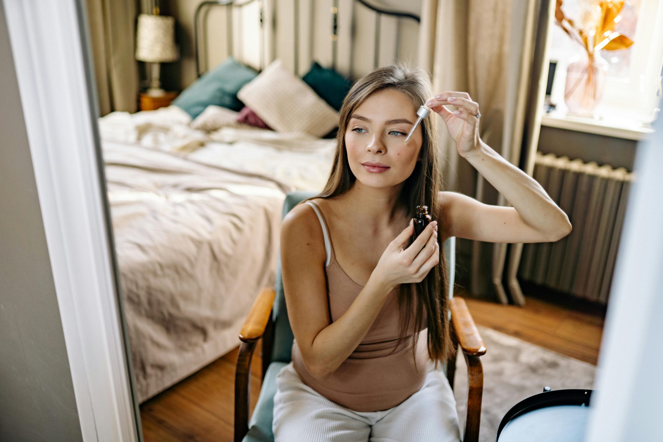 Woman applying niacinamide serum as part of her 30s skincare routine