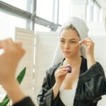 Woman applying niacinamide serum in morning skincare routine — niacinamide before and after results week by week