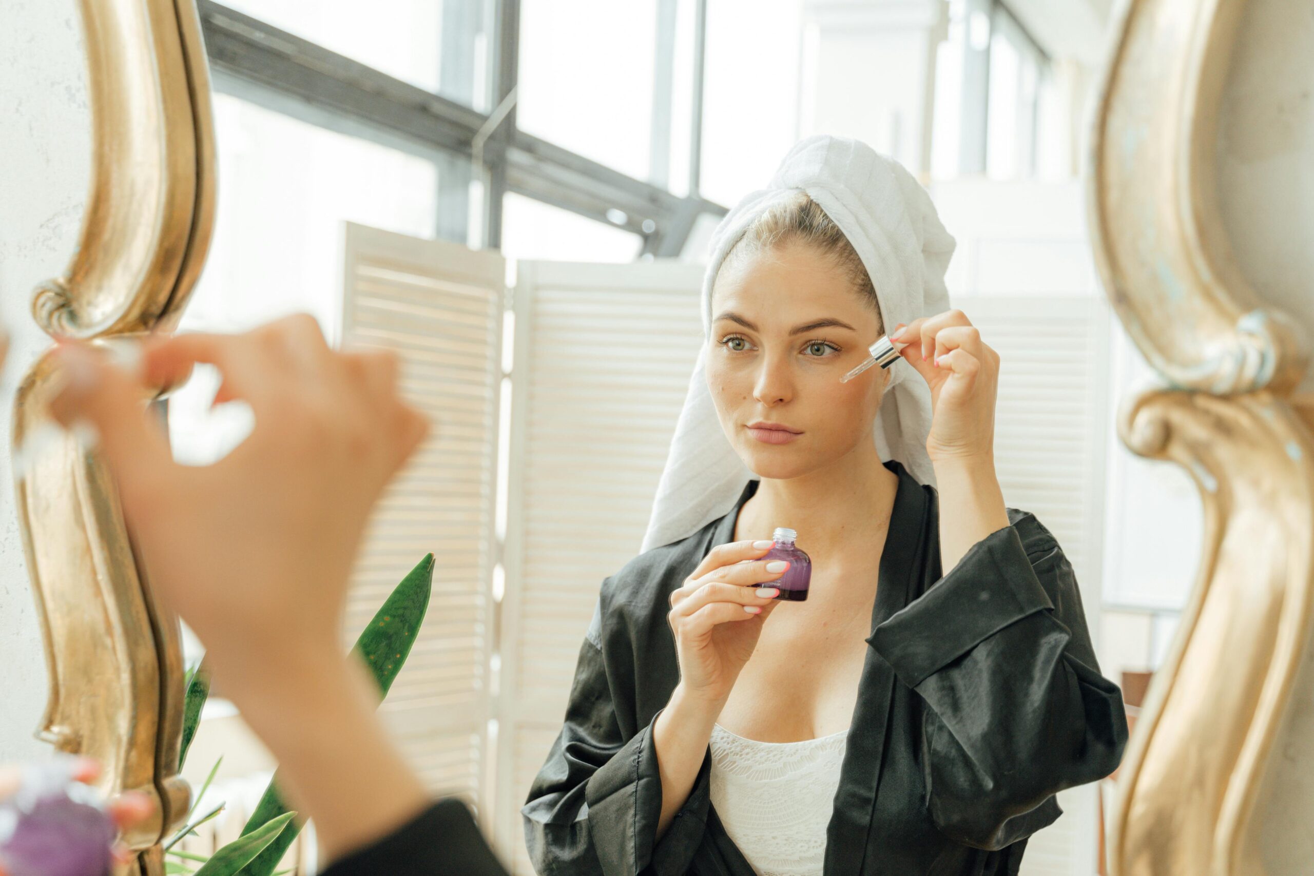Woman applying niacinamide serum in morning skincare routine — niacinamide before and after results week by week